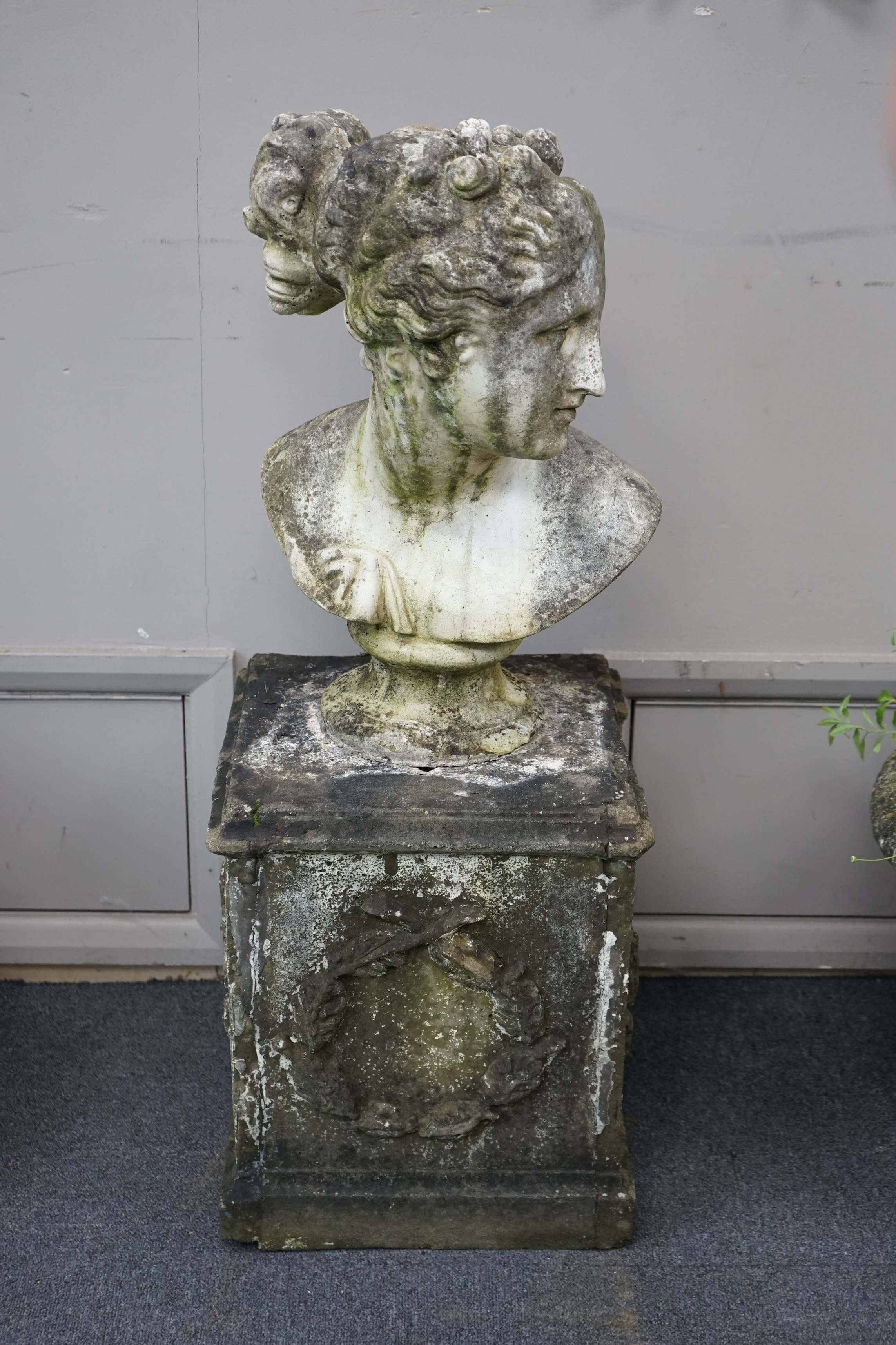 A reconstituted stone bust of Venus, on square pedestal